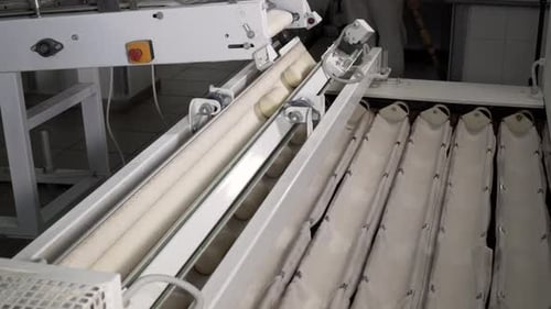 Timelapse. Making a Loaf of Bread in the Bakery. Loaf of Bread on the Production Line in the Baking