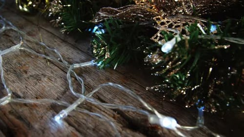Christmas Wreath and Lights on Wooden Surface