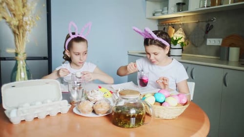 Little Girls Wearing Bunny Ears Painting Eggs on Easter Day