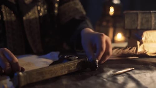 Man Writing with Quill in Candle Light