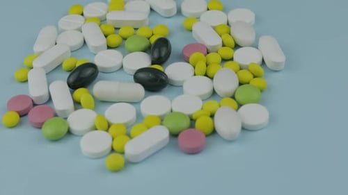 Pills and Capsules on a Light Blue Surface