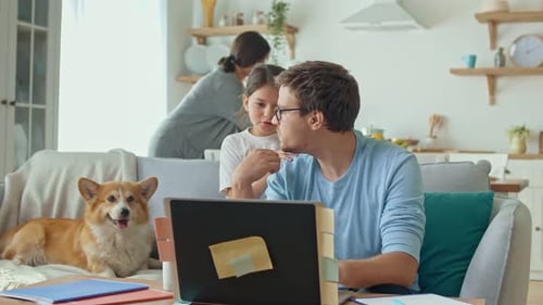 Family Together at Home with Laptop and Dog