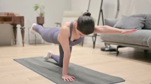 Woman Doing Yoga Arm and Leg Extension Exercise
