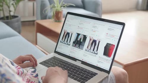 Man Shopping for Pants Online at Home