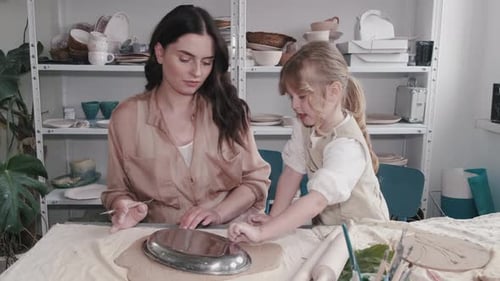 Woman and Child Working with Clay in Studio