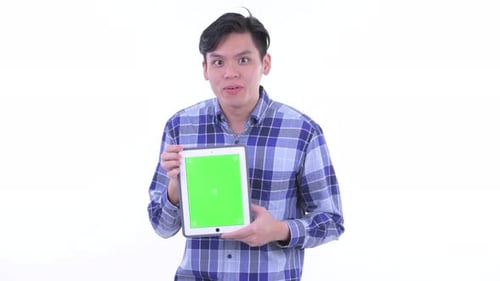 Young Adult Presenting Tablet with Green Screen