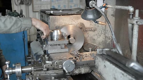 Machine Operator Working with Lathe in Factory