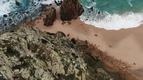 Seashore with Rocky Hills Near Sand Beach with Azure Waves