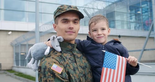 Soldier and Child with American Flag Smile