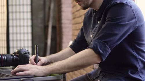 Graphic Designer Working with Stylus and Tablet