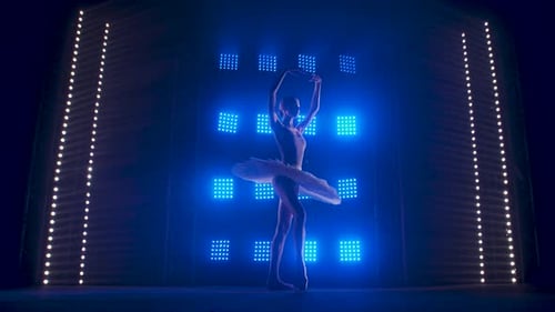 Ballerina Dancing on Stage with Blue Lights