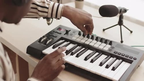 Musician Playing Keyboard in Home Studio