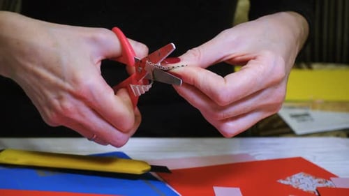 Close Up of Cutting Corrugated Cardboard with Scissors
