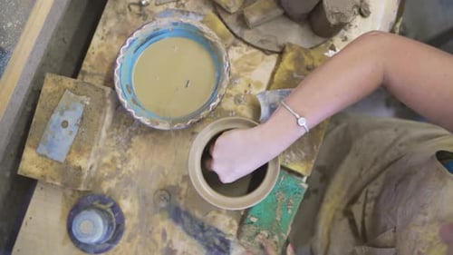 High Angle View of Female Potter Molding Brown Clay in Pottery Workshop