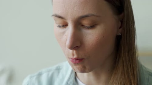 Close Up of the Mouth of a Woman Eating Potato Chips