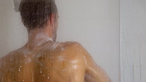 Muscular Man Taking a Shower