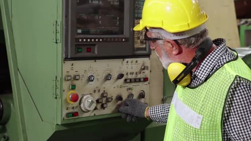 Senior Factory Worker Teach How to Use Machine Equipment in the Factory Workshop