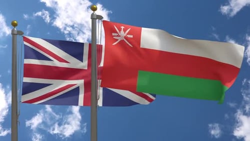 United Kingdom and Oman Flags Waving in the Sky