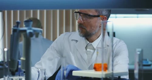 Scientist Scanning an Erlenmeyer Flask in Lab
