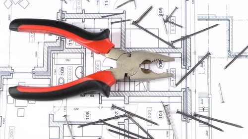 Gray and Red Pliers on Building Plan, Scheme Among Nails, Rotation