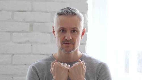 Frustrated Angry Middle Aged Man Yelling, Sitting in Office