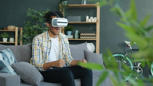 Man Experiencing Virtual Reality on Living Room Couch