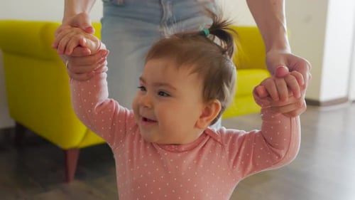 Close Up View of Happy Baby's Face Learning to Walk Toddler Taking First Steps