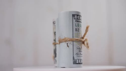 Two Stacks of Hundreddollar Bills Tied with a Rope Slowly Rotate