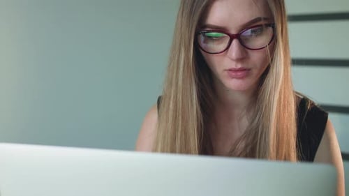 Portrait of Serious Woman Working with Laptop
