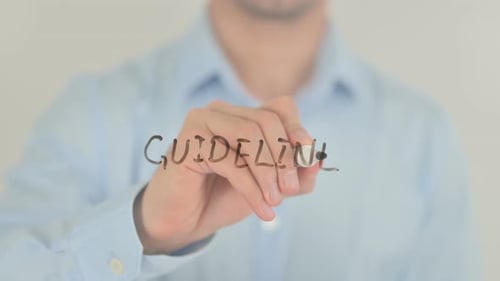 Man Writing Guideline on Transparent Surface Close Up