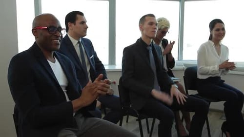 Business People Applauding in Modern Office Meeting