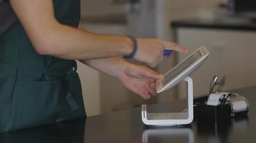 Close-up of credit card transaction at modern coffee shop