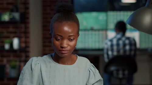 Young Adult Working at a Computer in an Office