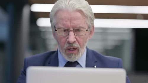 Close Up of Old Businessman Feeling Loss on Laptop