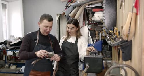 Craftsman and Woman Standing in a Workshop