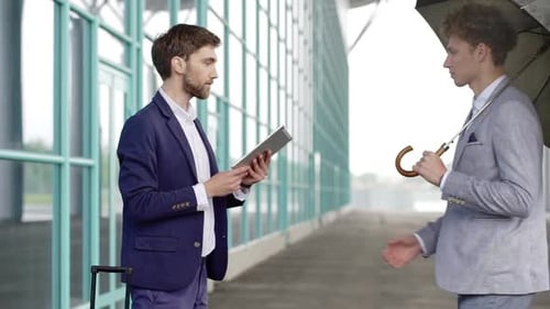 Two Businessmen Meet Outside Airport Shake Hands Corporate Meeting Executive Ceo Looking at Business