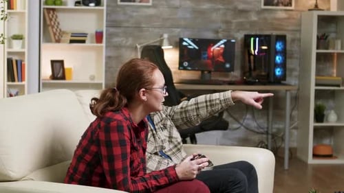 Couple Playing Video Games at Home on Couch