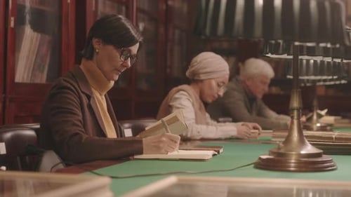University Professor Preparing for Lecture in Library