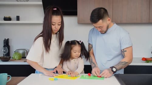 Family Shapes Colorful Clay in Kitchen