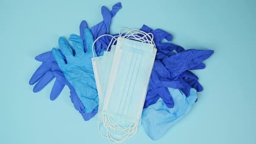 Face Masks Placed on Pile of Medical Gloves