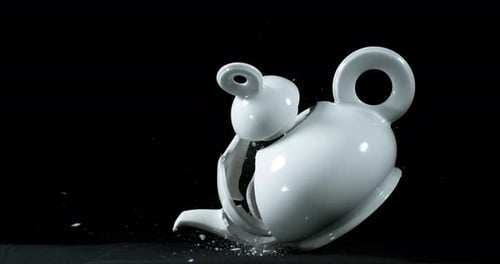 Tea-Pot falling and exploding on Black Background, Slow Motion 4K