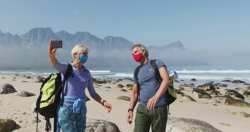 Smiling Couple Takes Beach Selfie During Hike