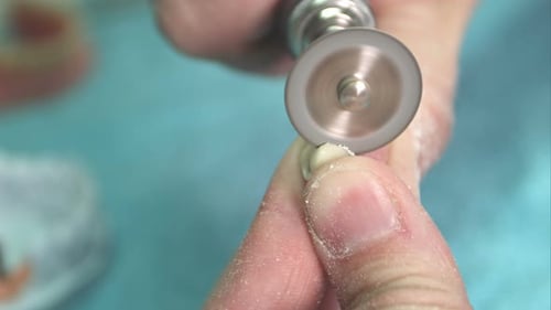 Dental Technician Shaping a Custom Crown with Precision