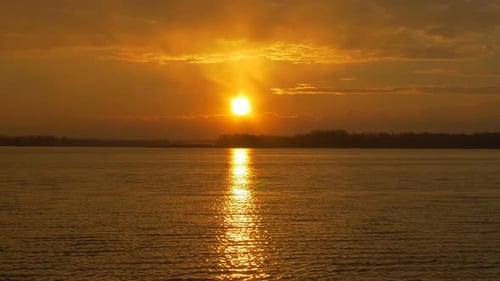 Colour Sunset Over The River With Sun And Orange Clouds
