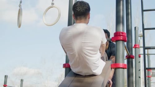 Young Man Doing Sit-ups on an Ab Board