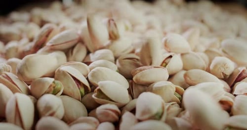 Pistachios Falling onto a Pile Close Up