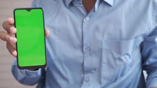 Close Up of Young Man Hand Using Smart Phone with Green Screen