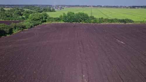 Tractor in the Dust Working in the Field