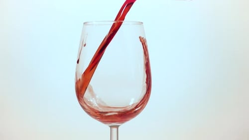 Pouring red wine into a glass