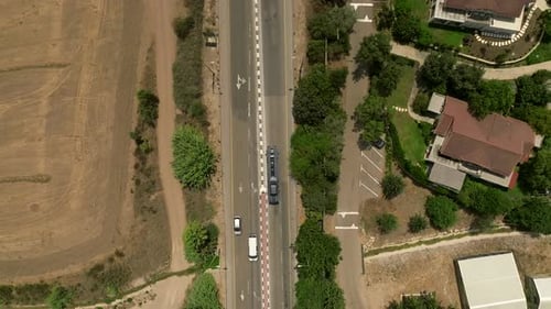 Tow truck carrying a single car on a rural highway, Aerial follow footage.
